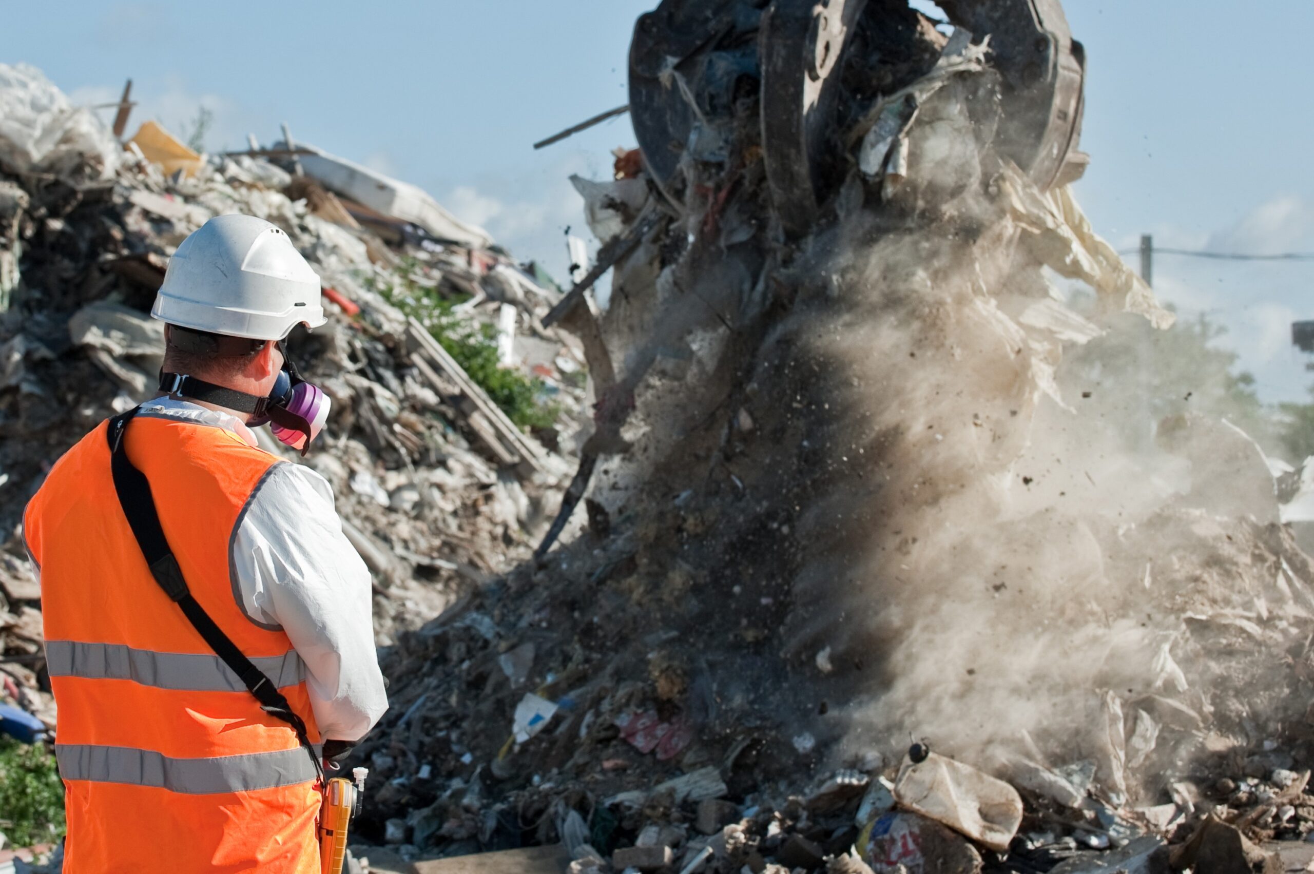 A pile of waste being grabbed by a claw