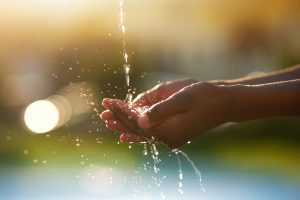 Water is precious. Closeup shot of hands held out under a stream of water