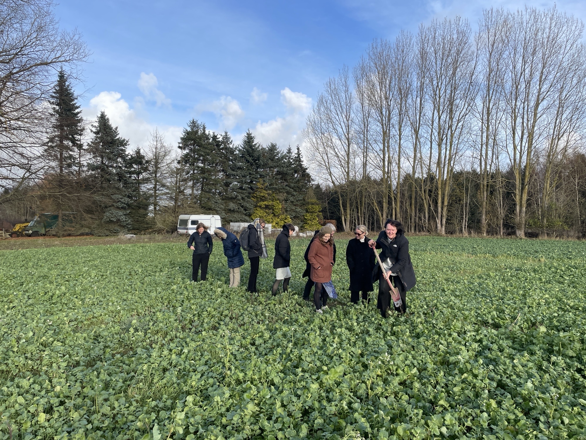 The carbon Removal and CCUS delegation walking in a green field with biochar
