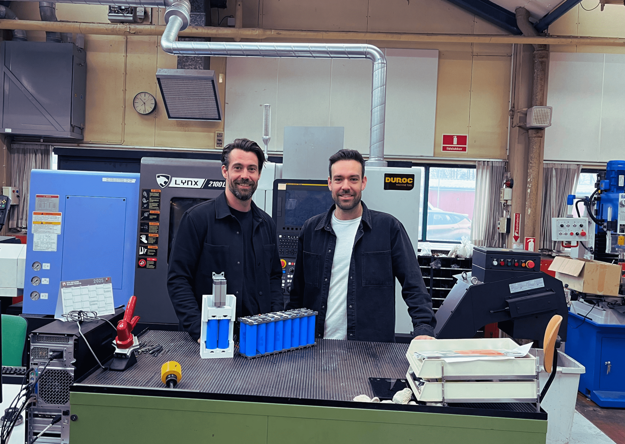 Mikkel and Lasse standing with their batterypack